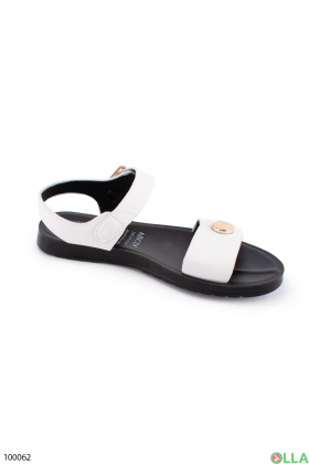 Women's white sandals on a low run