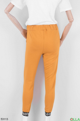 Жіночі помаранчеві спортивні штани