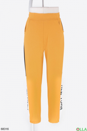 Жіночі помаранчеві спортивні штани з написом