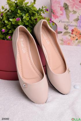 Beige flats with a brooch