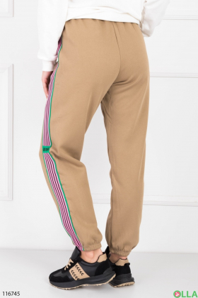 Жіночі бежеві спортивні брюки на флісі