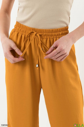 Жіночі темно-жовті брюки-палаццо
