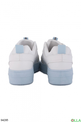 Women's white sneakers with blue soles