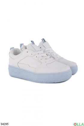 Women's white sneakers with blue soles