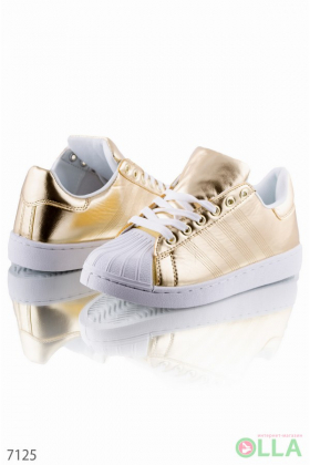 Gold sneakers with white toe